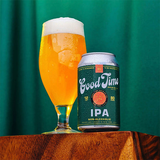 Good Time Brewing's NA IPA can sitting beside a glass of beer on a table.